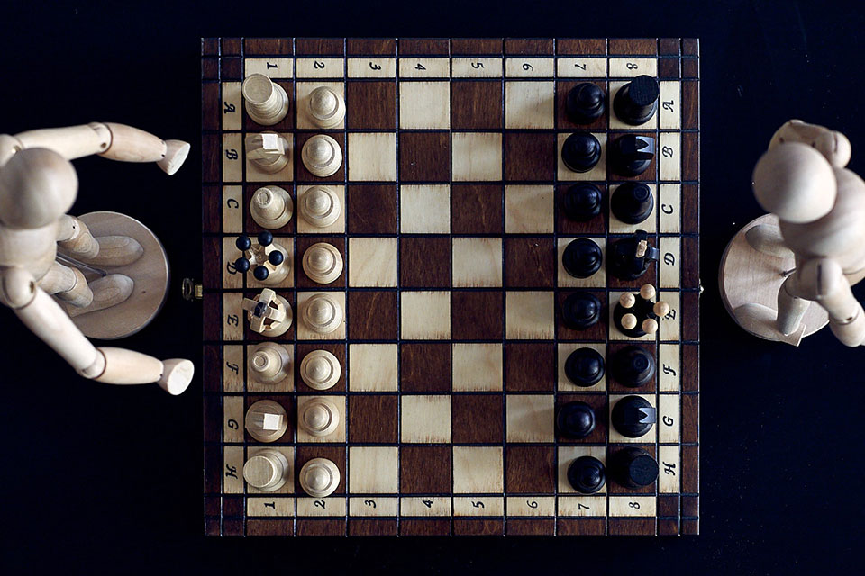 Couples therapy example with wooden figures playing chess